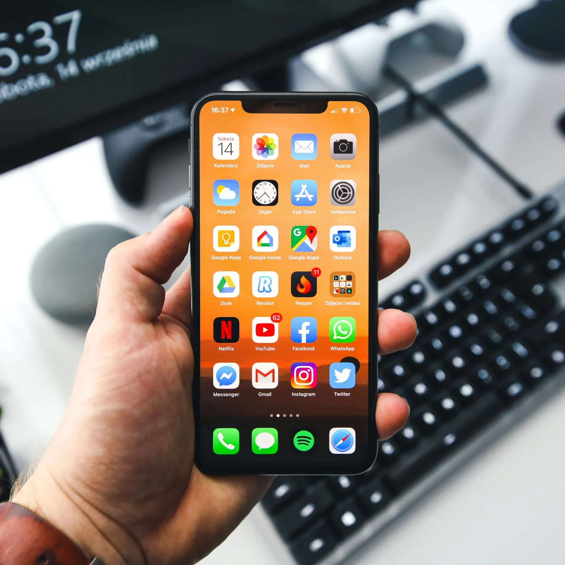 Hand holding a fully repaired iPhone at Hardy Repairs in Braintree