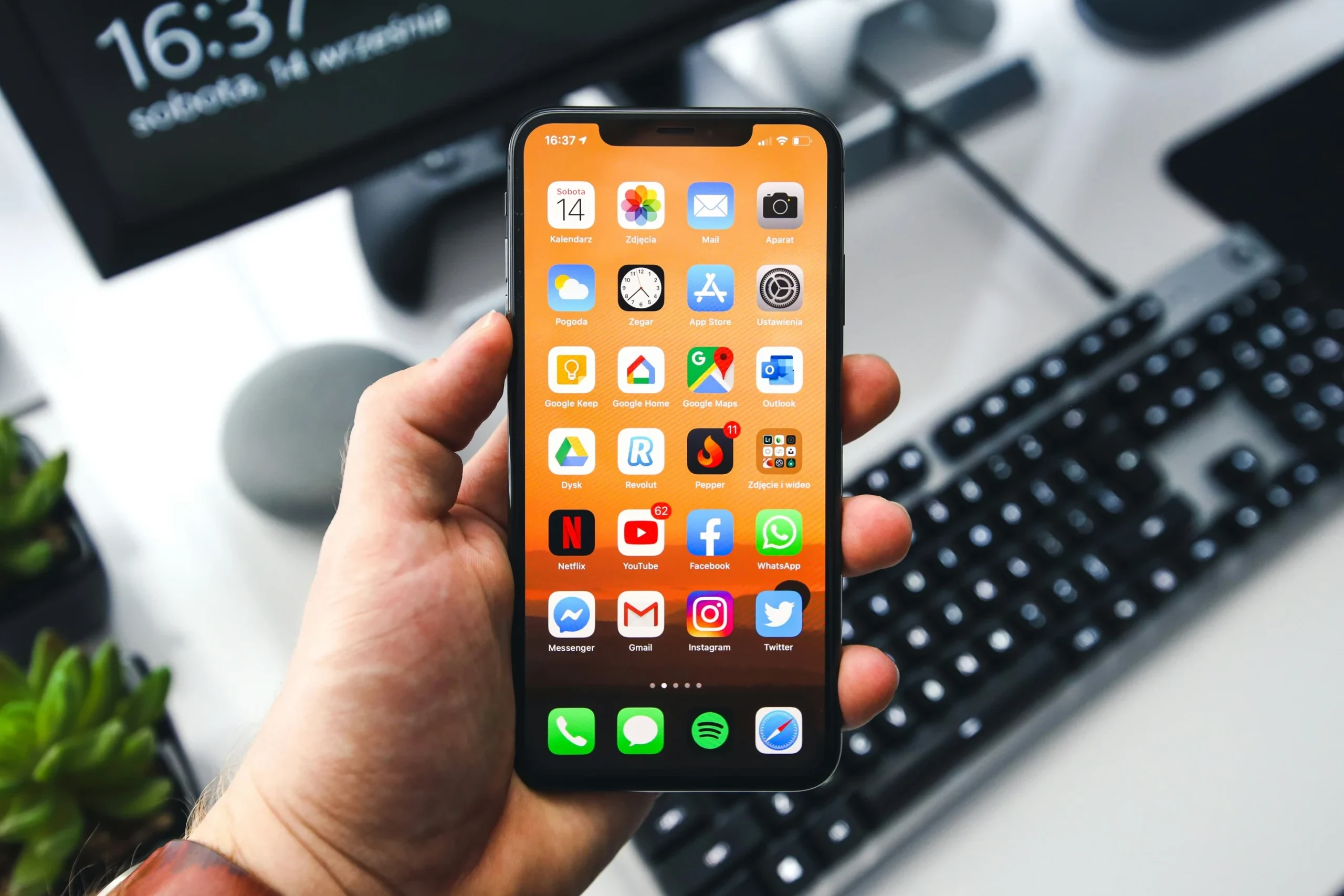 Hand holding a fully repaired iPhone at Hardy Repairs in Braintree