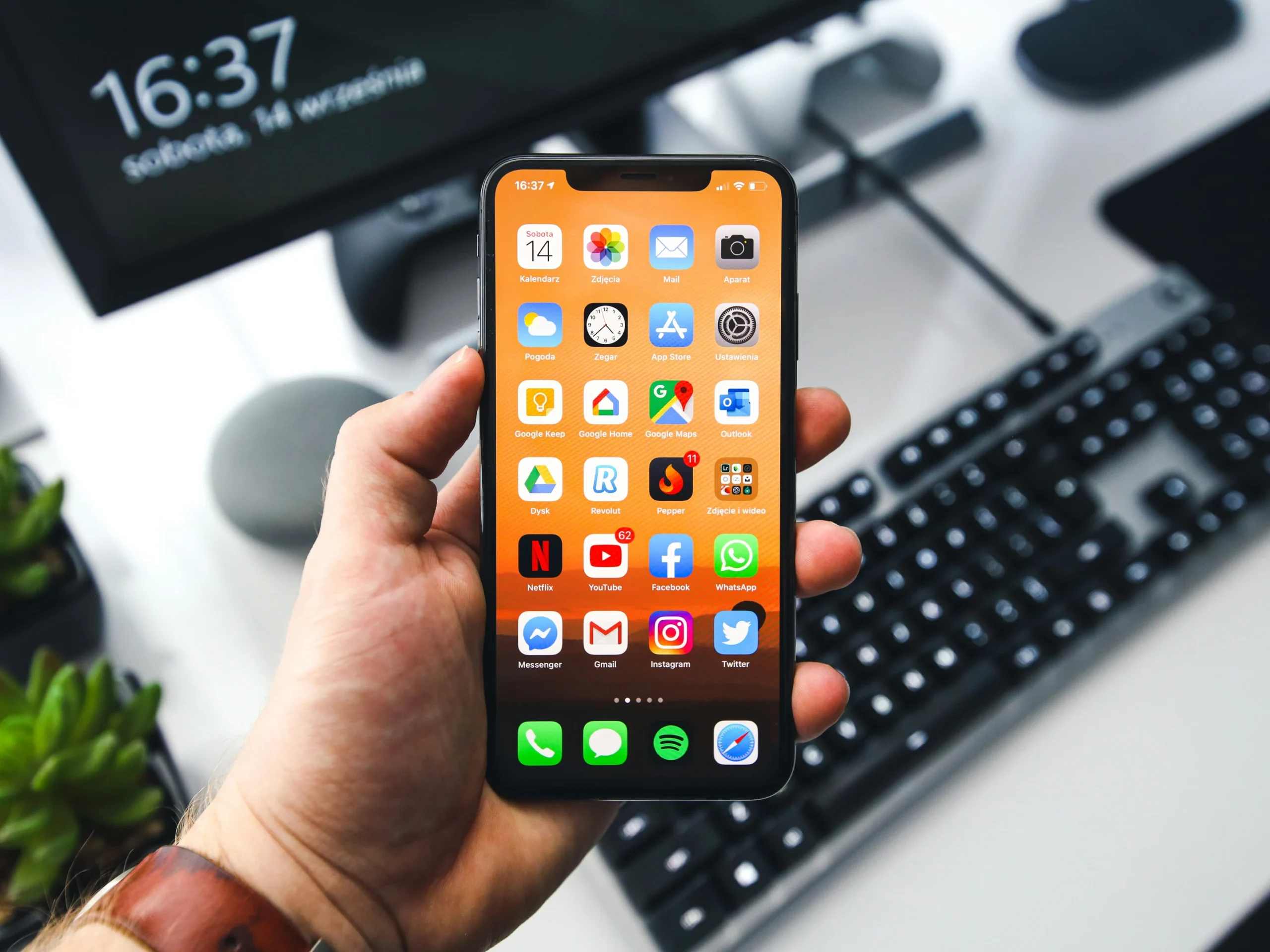 Hand holding a fully repaired iPhone at Hardy Repairs in Braintree